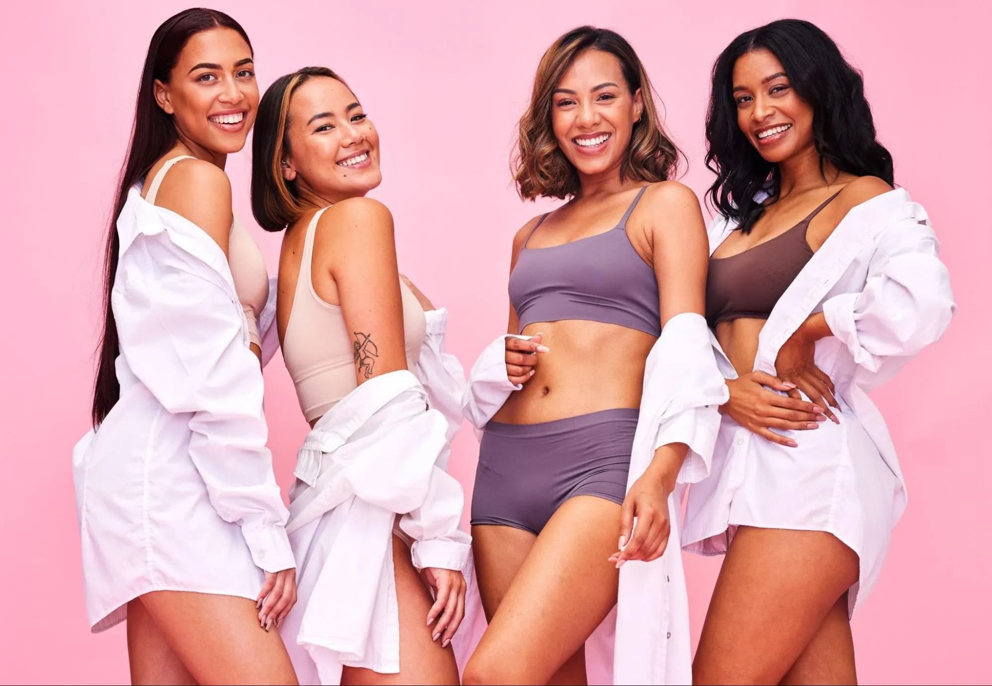 Diverse group of happy women, smiling confidently, celebrating body sculpting results and body positivity.