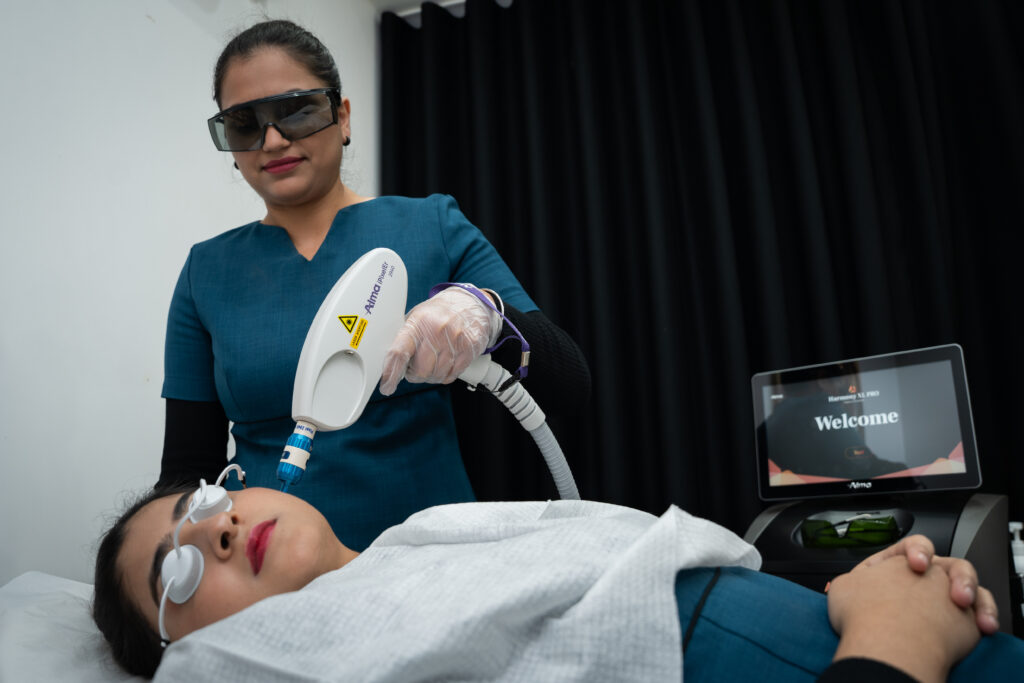 Woman getting facial laser hair removal treatment by a licensed aesthetician.